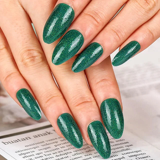 Glossy emerald press-ons with holographic glitter finish. Tech-friendly almond shape for comfortable typing. Easy 3-minute application.