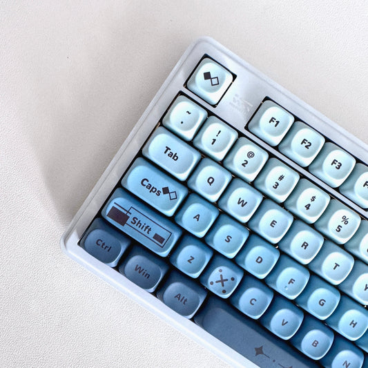 The Siren Series 09 full-size keyboard, ice white to deep ocean blue gradient keys with numpad, by Claws x Code