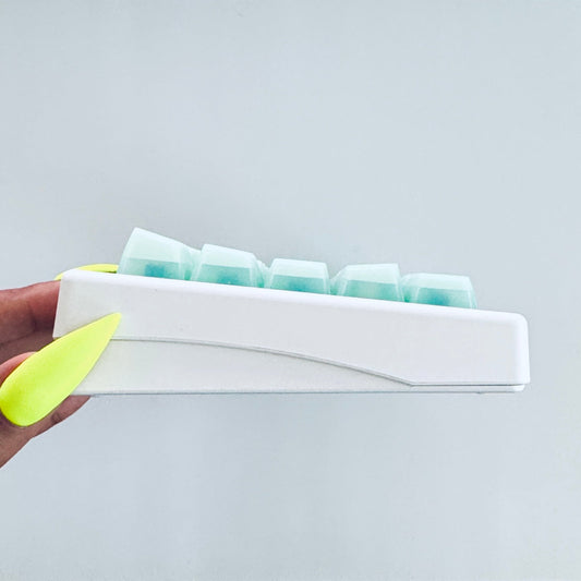 The Mint Assembly mechanical keyboard, mint green with teal iridescent-flake keycaps, Claws x Code