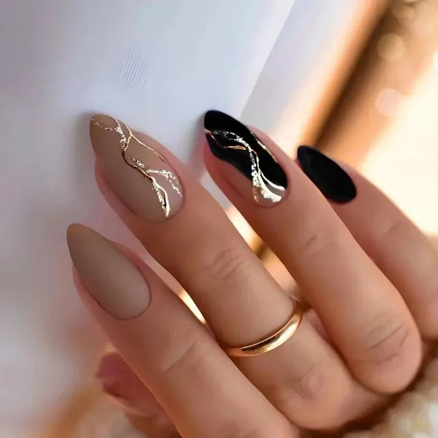 Elegant matte almond nails in nude & black with chrome wave accents. Tech-optimized length for typing comfort. Free shipping included.