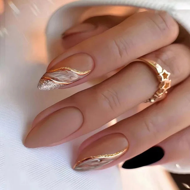 Elegant matte nude press-ons with gold marble & glitter accents. Tech-friendly almond shape, keyboard-optimized length. Ships free.