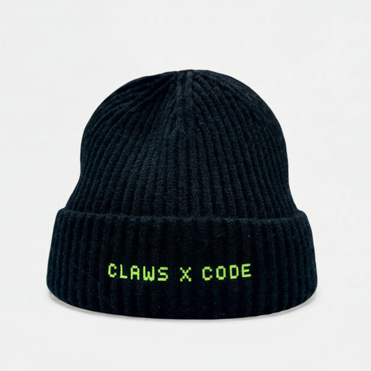 Black beanie with CLAWS X CODE 8-bit text on a knit fisherman's beanie.
